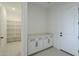 Well-lit mudroom featuring storage cabinets and a door for easy access to outside at 11045 N Hershey St, Surprise, AZ 85388