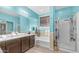 Bright bathroom with double sink vanity, tub, and glass-enclosed shower at 11742 W Chase Ln, Avondale, AZ 85323