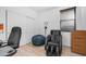 Bedroom with wood-look flooring, white walls, and a black massage chair at 11742 W Chase Ln, Avondale, AZ 85323