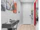 Bright foyer with a modern console table, stylish light-up tree decor and a neutral color palette at 11742 W Chase Ln, Avondale, AZ 85323