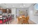 Open-concept kitchen and dining area with modern appliances, stylish bar seating and a sliding glass door at 11742 W Chase Ln, Avondale, AZ 85323