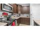 Kitchen details include stainless steel microwave, dark cabinets, and black electric range at 11742 W Chase Ln, Avondale, AZ 85323