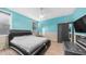 Modern bedroom features accent wall, wood-look flooring and dark furniture at 11742 W Chase Ln, Avondale, AZ 85323