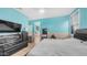 Spacious main bedroom boasts aqua walls, wood-look floors, and ample natural light at 11742 W Chase Ln, Avondale, AZ 85323