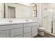 Well-lit bathroom featuring double sinks and a glass-enclosed shower at 12381 W Marguerite Ave, Avondale, AZ 85323