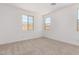 Inviting bedroom offers neutral carpet and two bright, sunny windows at 12381 W Marguerite Ave, Avondale, AZ 85323