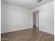 Bright bedroom with wood-look tile flooring leading to the doorway at 12381 W Marguerite Ave, Avondale, AZ 85323