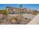 Inviting home exterior with a three-car garage and decorative landscaping at 12381 W Marguerite Ave, Avondale, AZ 85323