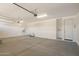 Spacious three-car garage with ample storage and lighting for organization at 12381 W Marguerite Ave, Avondale, AZ 85323