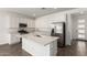 Modern kitchen featuring white cabinetry, stainless appliances and a large center island at 12381 W Marguerite Ave, Avondale, AZ 85323
