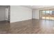 Open-concept living space features wood-look floors and sliding glass doors to the yard at 12381 W Marguerite Ave, Avondale, AZ 85323