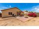 Large backyard featuring a brick fire pit and covered patio, perfect for outdoor relaxation at 12606 W Scotts Dr, El Mirage, AZ 85335