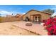 Backyard features a cozy patio cover, and a blooming bougainvillea adding vibrant color at 12606 W Scotts Dr, El Mirage, AZ 85335