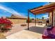 Backyard with a fire pit and patio cover, great for entertaining outdoors at 12606 W Scotts Dr, El Mirage, AZ 85335