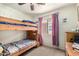 bedroom with wooden bunkbeds and cute lilac curtains for a cozy feel at 12606 W Scotts Dr, El Mirage, AZ 85335