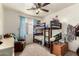 Bright bedroom with bunkbeds, comfortable chair, and a ceiling fan at 12606 W Scotts Dr, El Mirage, AZ 85335