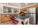 The kitchen features wooden cabinetry, stainless steel appliances, and a kitchen island at 12606 W Scotts Dr, El Mirage, AZ 85335