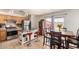The kitchen features wooden cabinetry, stainless steel appliances, and an adjacent dining area at 12606 W Scotts Dr, El Mirage, AZ 85335