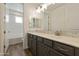 Bright bathroom features gray cabinetry, wood look tile flooring and a granite countertop at 12816 N 172Nd Dr, Surprise, AZ 85388