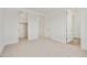 Bright bedroom featuring neutral-toned carpeting and multiple closet doors at 12816 N 172Nd Dr, Surprise, AZ 85388