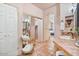 View of the bathroom with tiled floor, sink, storage cart with towels, and view into bedroom at 13250 N 13Th Ln, Phoenix, AZ 85029