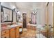 Bathroom with tile floor, double sinks, mirrors, sconces, soaking tub, and shower at 13250 N 13Th Ln, Phoenix, AZ 85029