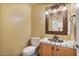 Stylish half bathroom with decorative mirror, vanity and tiled countertop at 13250 N 13Th Ln, Phoenix, AZ 85029