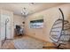 Bedroom features a chandelier, tiled floor, and hanging chair at 13250 N 13Th Ln, Phoenix, AZ 85029