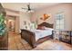 Bedroom featuring a bed, ceiling fan, and access to bathroom, patio, and exterior at 13250 N 13Th Ln, Phoenix, AZ 85029