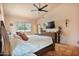 Bedroom featuring a bed, ceiling fan, dresser with TV, sconces, and view of the backyard at 13250 N 13Th Ln, Phoenix, AZ 85029