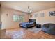 Cozy bedroom featuring tile floors, a chandelier, a comfortable bed, and a window with natural light at 13250 N 13Th Ln, Phoenix, AZ 85029