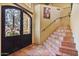 Elegant entryway with tile floors, decorative staircase, and wrought iron door at 13250 N 13Th Ln, Phoenix, AZ 85029