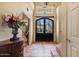 Grand foyer showcasing elegant tile flooring and an ornate wrought iron front door at 13250 N 13Th Ln, Phoenix, AZ 85029