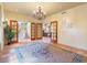 Elegant foyer boasts tiled floors, decorative chandelier, and inviting doorways leading to other spaces at 13250 N 13Th Ln, Phoenix, AZ 85029