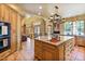 Spacious kitchen island with bar seating, custom cabinetry and stainless appliances and an open layout at 13250 N 13Th Ln, Phoenix, AZ 85029