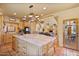 Bright kitchen with a large island, custom cabinets, stainless appliances and a seamless flow to the dining room at 13250 N 13Th Ln, Phoenix, AZ 85029