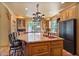 Spacious kitchen island with countertops, copper sink, and wooden cabinets, complemented by stainless steel appliances at 13250 N 13Th Ln, Phoenix, AZ 85029
