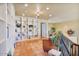 Bright loft featuring built-in shelving, tiled flooring, a cozy orange sofa, and multiple windows at 13250 N 13Th Ln, Phoenix, AZ 85029