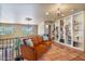 Bright loft featuring a comfortable orange sofa, built-in shelving, and scenic views from the windows at 13250 N 13Th Ln, Phoenix, AZ 85029