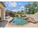 Refreshing pool area with a rock waterfall and lush landscaping at 13250 N 13Th Ln, Phoenix, AZ 85029
