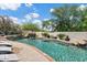 Inviting pool featuring a waterfall, lush greenery, and comfortable lounge chairs for relaxation under the sun at 13250 N 13Th Ln, Phoenix, AZ 85029