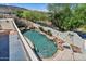 Backyard pool with waterfall, lush landscaping, and tranquil water feature at 13250 N 13Th Ln, Phoenix, AZ 85029