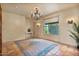Inviting room with tile flooring, chandelier, and bright window with views of the greenery outside at 13250 N 13Th Ln, Phoenix, AZ 85029