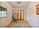 Sitting room with a swing chair, tiled floors, rug, window, and entry doors with glass at 13250 N 13Th Ln, Phoenix, AZ 85029