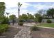Lush backyard showcasing a wrought iron fence, mature landscaping and desert landscaping at 13486 W Evans Dr, Surprise, AZ 85379