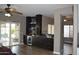 Stylish bar area with dark wood cabinets, wine storage, cooler, and marble backsplash at 13486 W Evans Dr, Surprise, AZ 85379