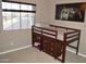 Cozy bedroom with a raised bed, built in storage, and natural light from the window at 13486 W Evans Dr, Surprise, AZ 85379