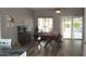 Dining room featuring wood floors, dining table with seating, and access to backyard at 13486 W Evans Dr, Surprise, AZ 85379