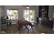 Dining room featuring wood floors, dining table with seating, and access to backyard at 13486 W Evans Dr, Surprise, AZ 85379
