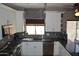 Modern kitchen with white cabinetry, stainless steel appliances, and stylish backsplash at 13486 W Evans Dr, Surprise, AZ 85379